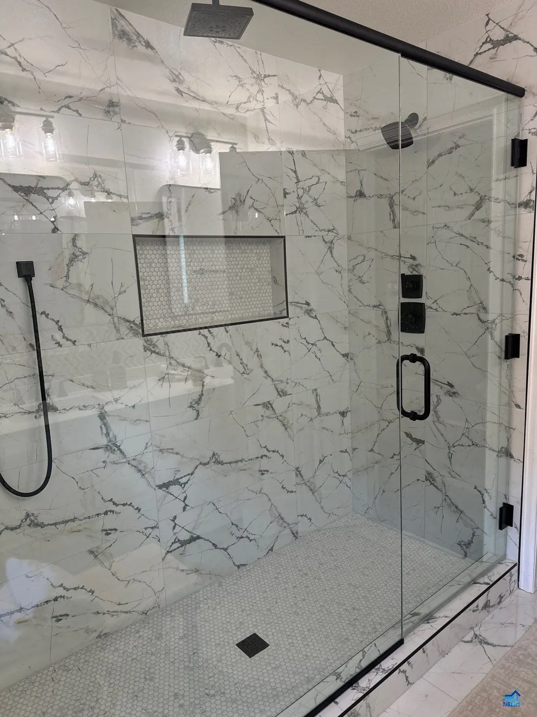 Double-sink marble vanity with black countertop ledges above a black-and-white checkerboard floor