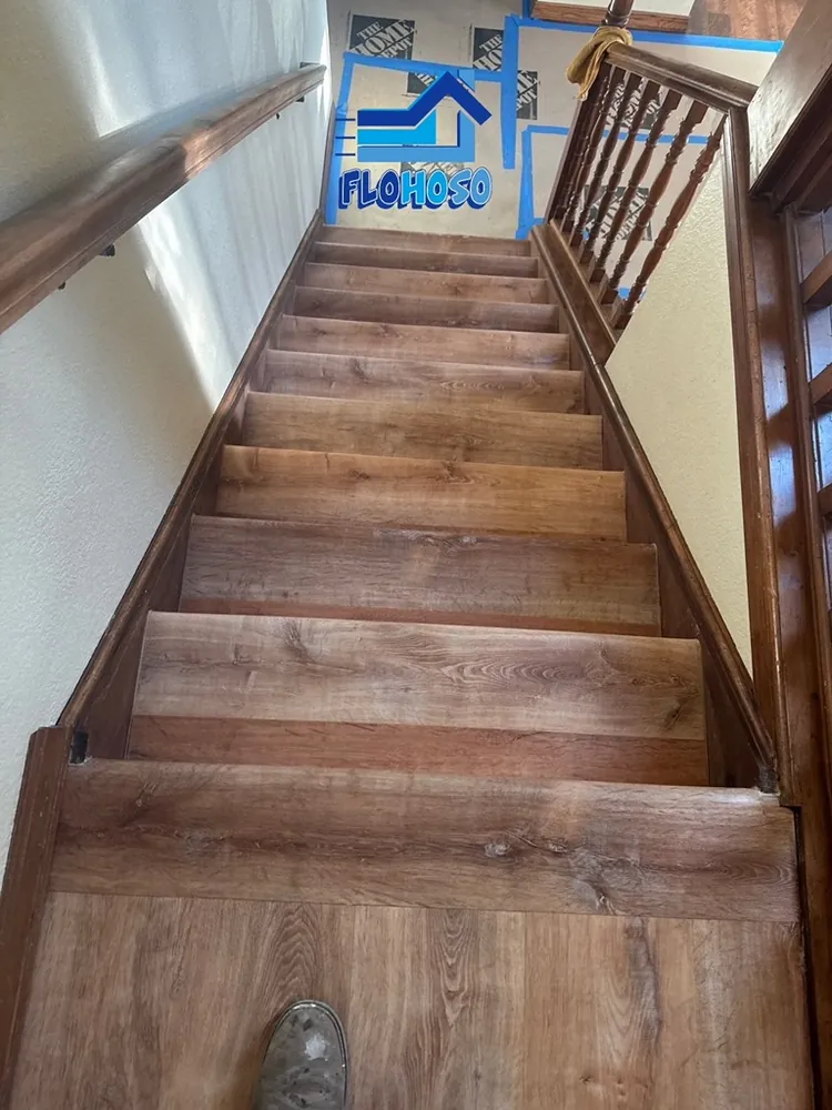 Newly installed hardwood staircase with stained wood treads and risers